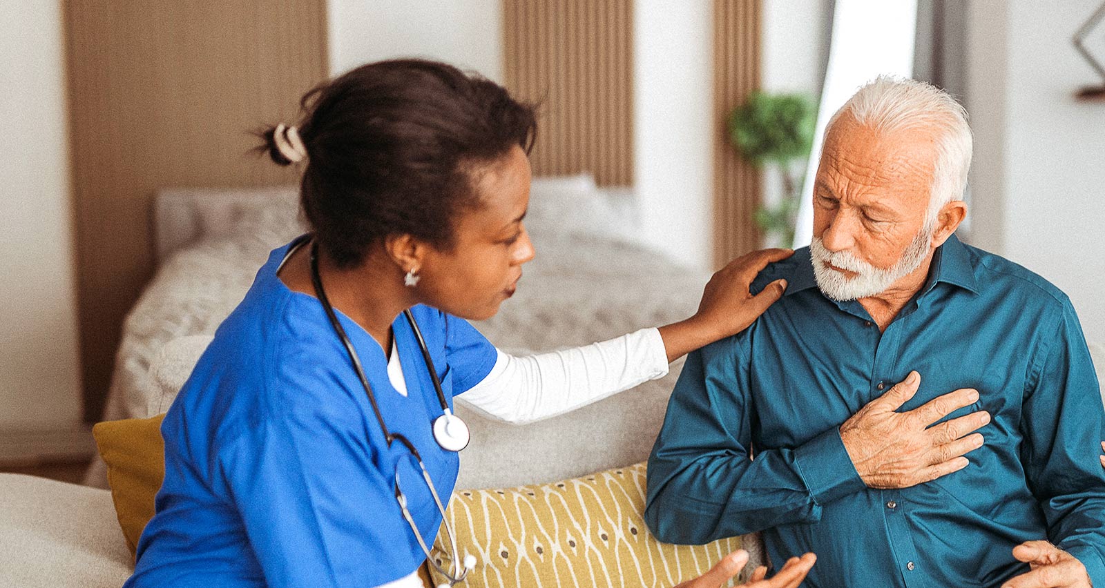 Doctor visiting senior heart patient