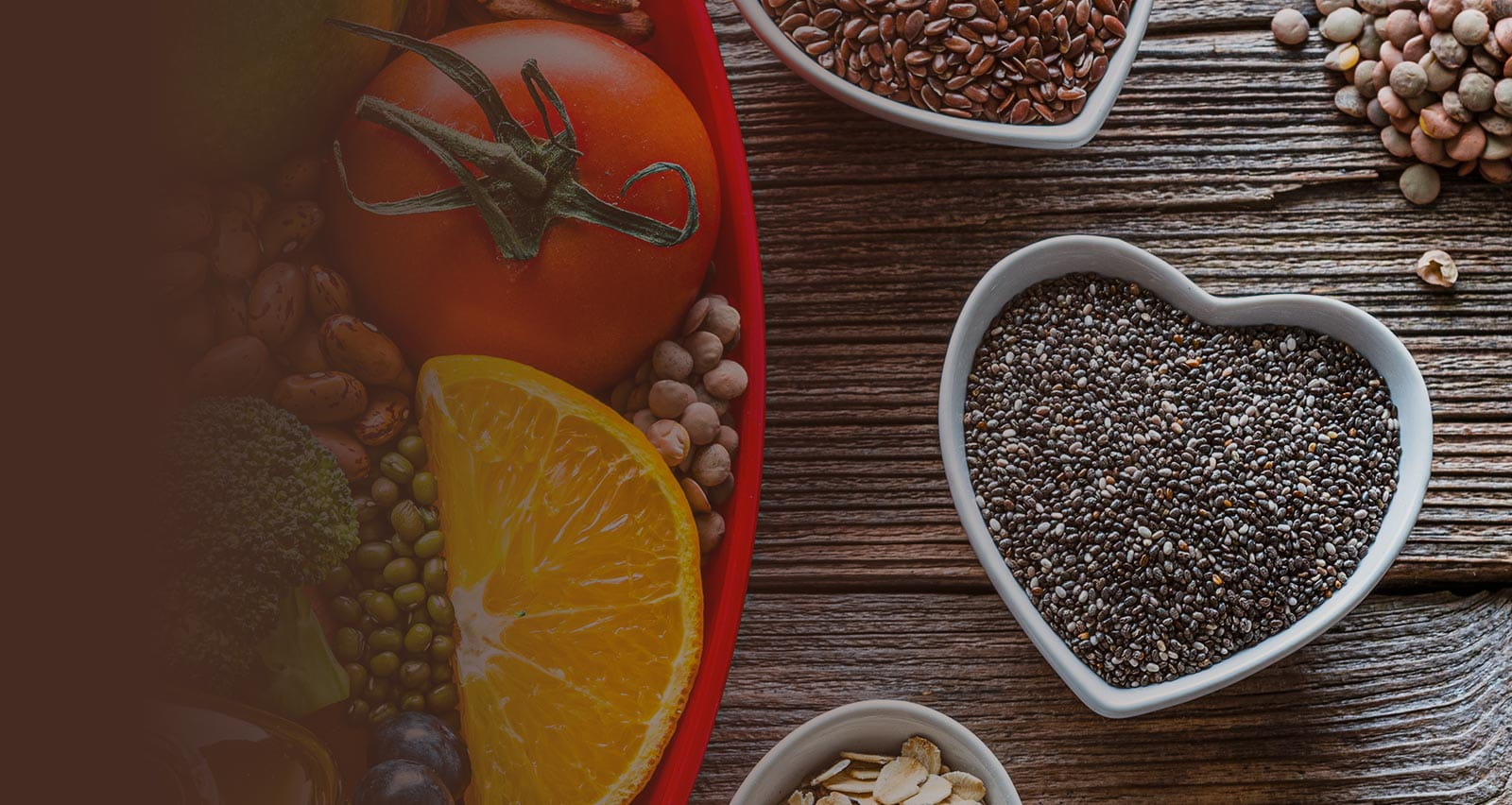 A group of fresh multicolored foods intended to help lower cholesterol levels spread atop a wooden table