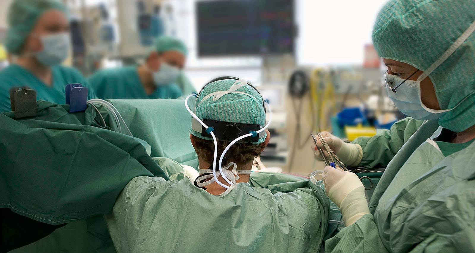 Team of heart surgeons performing coronary artery bypass grafting procedure