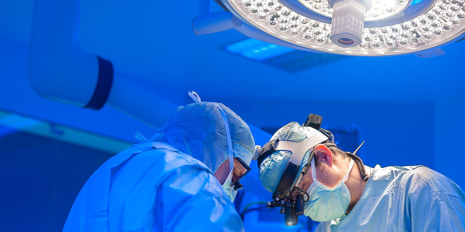 Surgeons performing open heart surgery in modern operation room