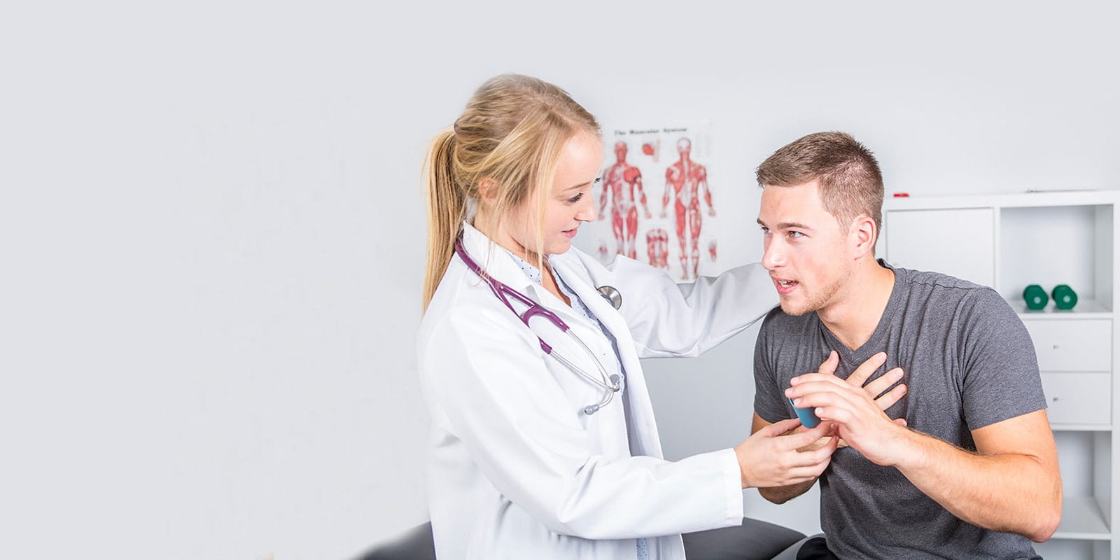 Man describing his shortness of breath to doctor.