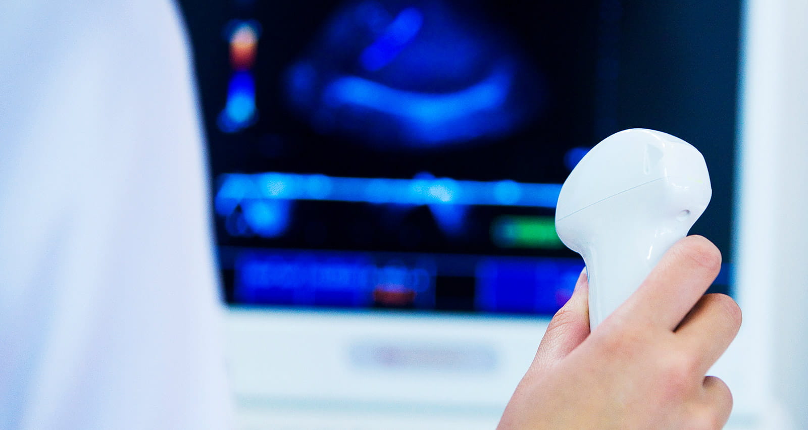A technician holds an ultrasound scanning device