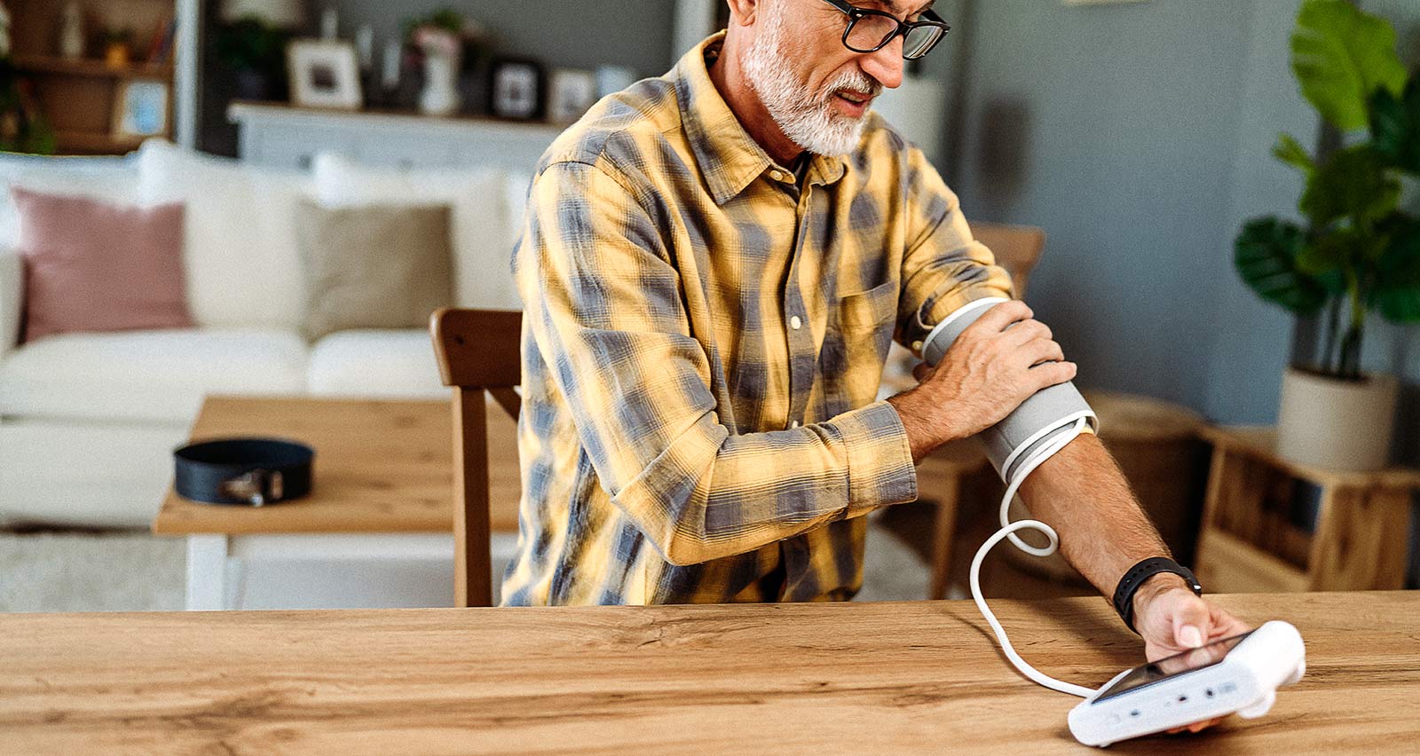 A senior man measuring his blood pressure