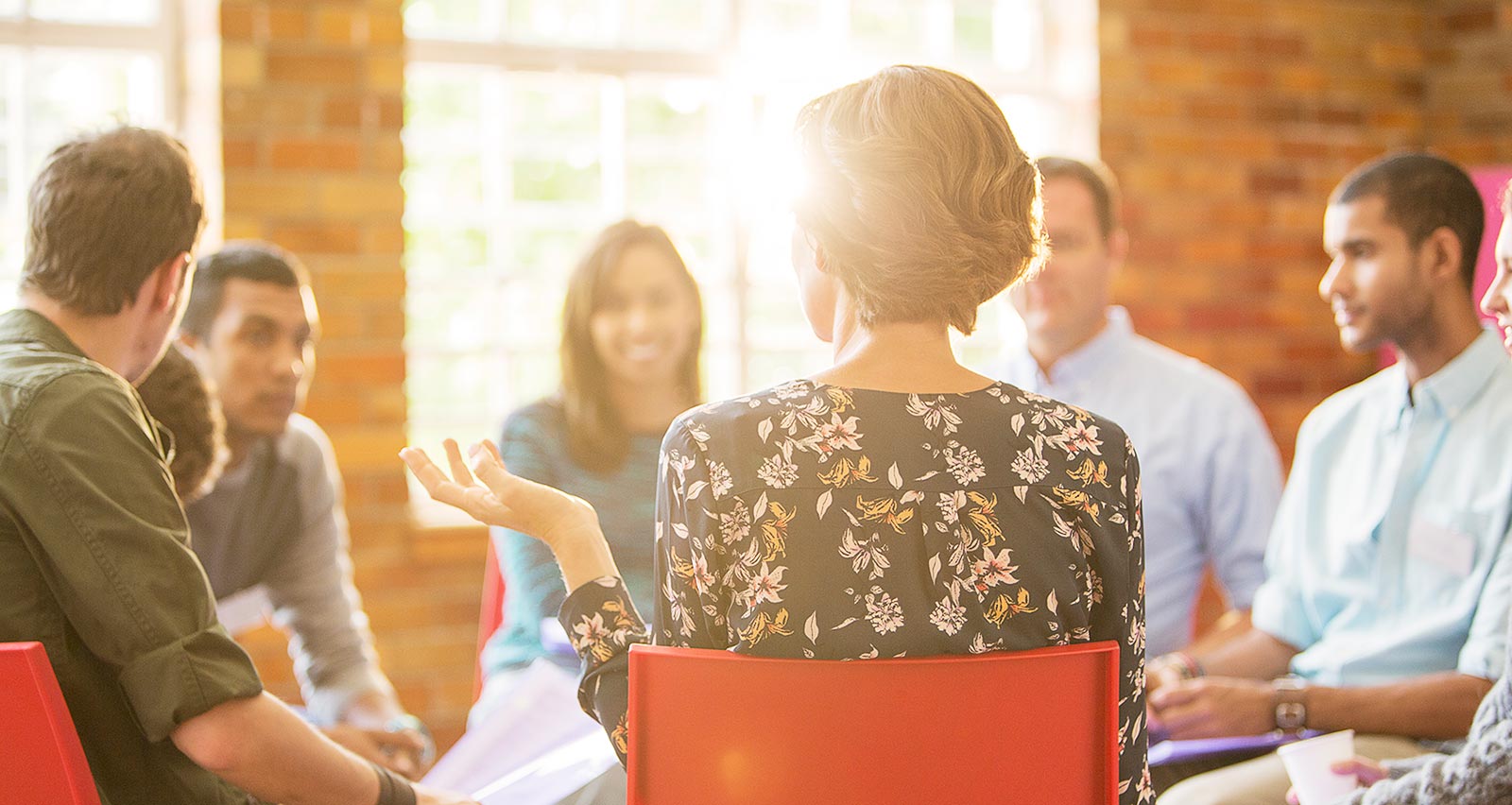 A woman speaking in group therapy session