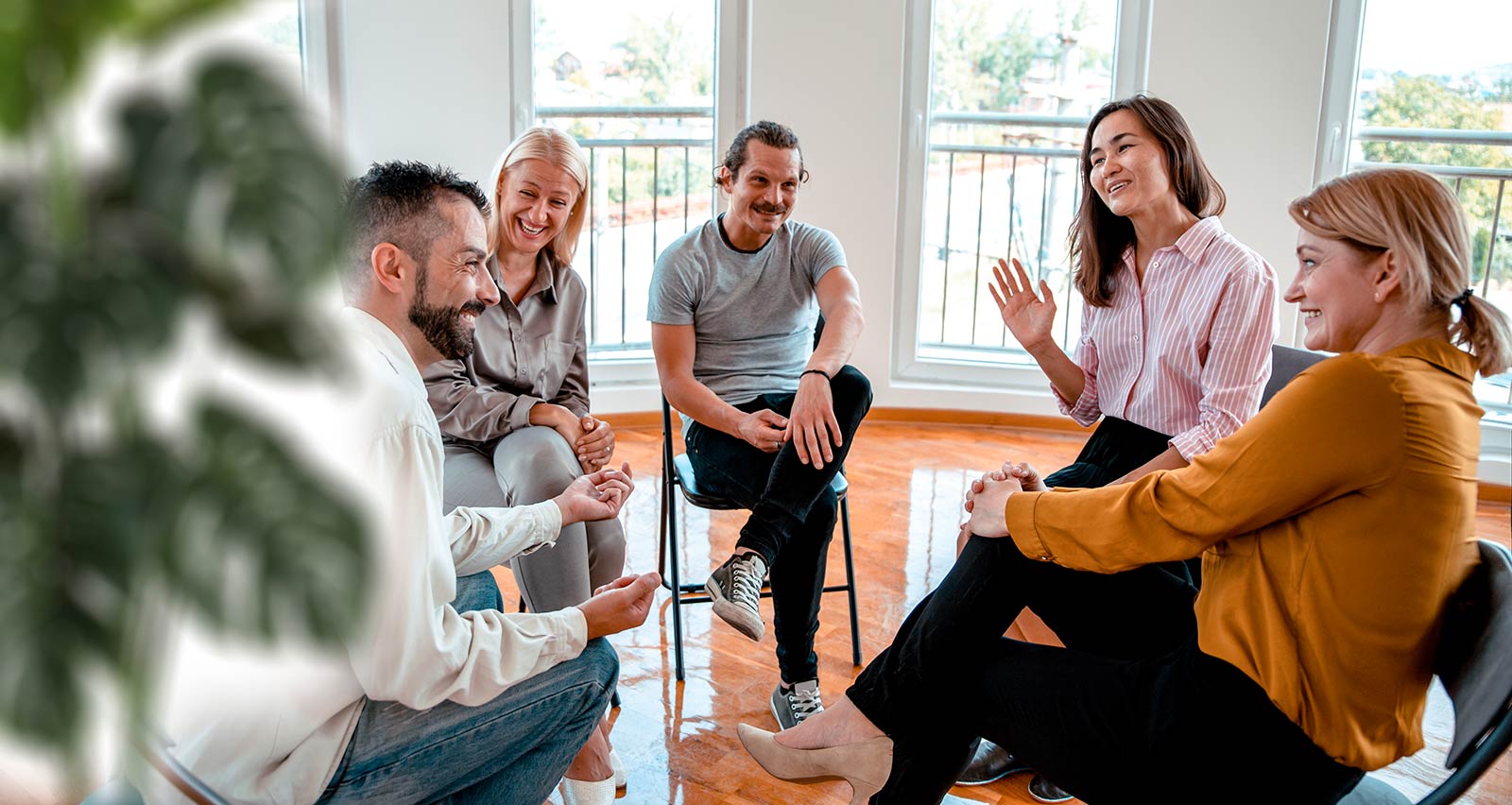 A diverse group of people sitting in a circle in a rehabilitation center
