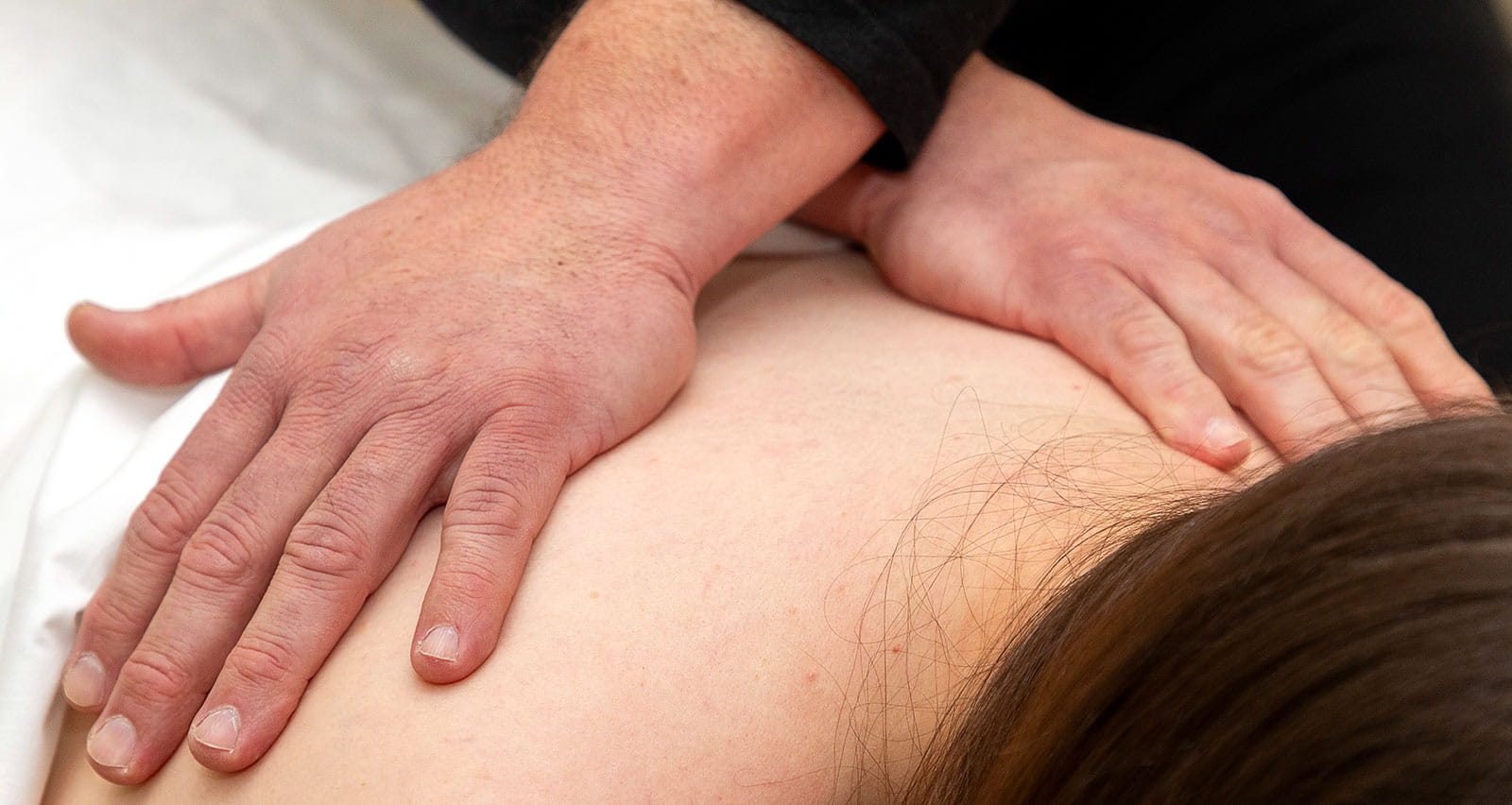 Massage Therapist Carlos Gonzalez, LMT with a patient