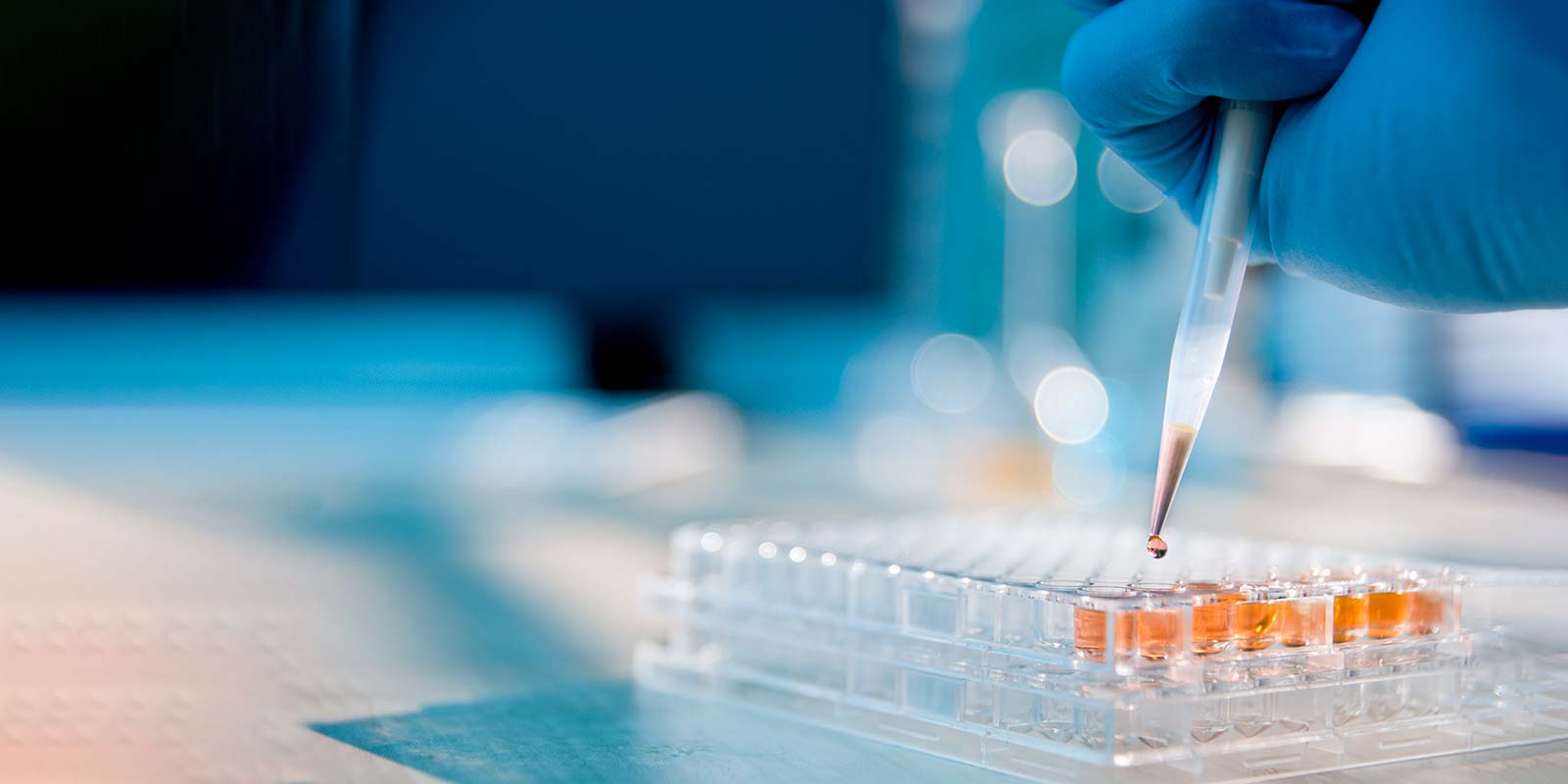 Lab Technician Filling Test Tubes