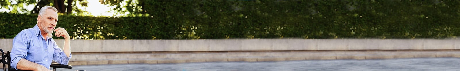 Man in wheelchair thinking outside.