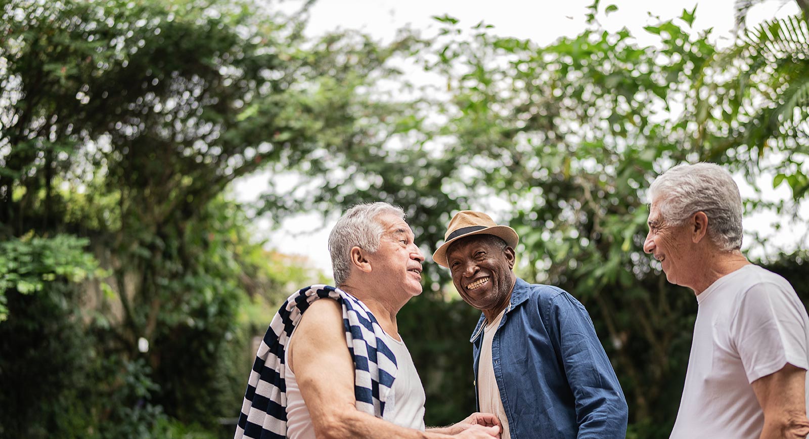 Three senior men having fun outside
