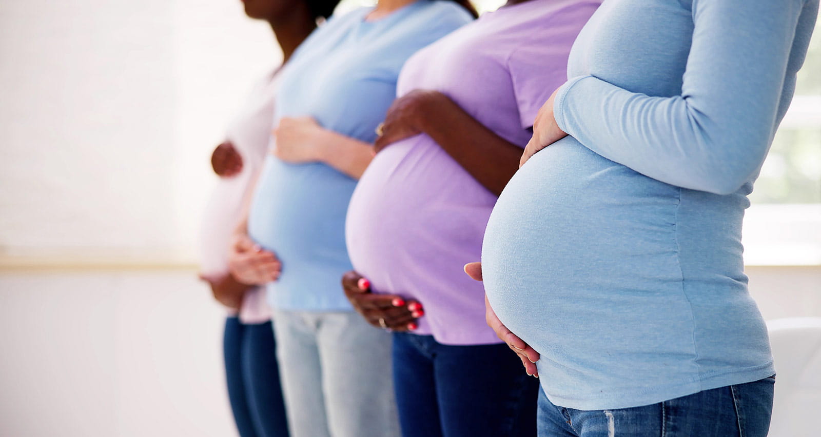 Four pregnant women in a row