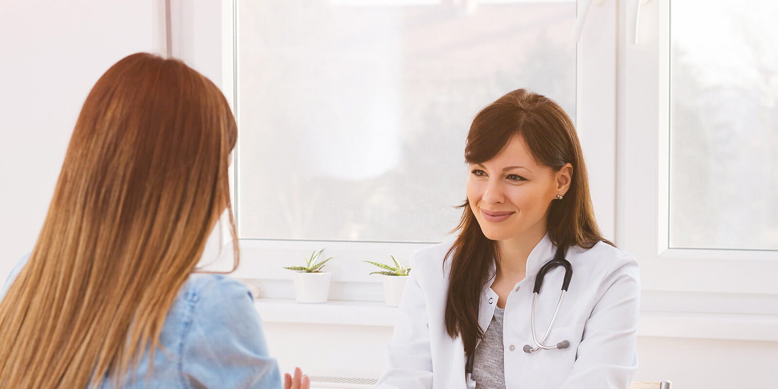 Woman talking to her doctor about the latest medicine breakthroughs.