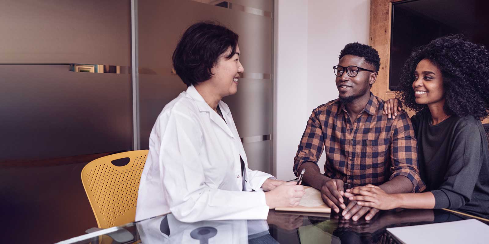 Female doctors consultation with a couple in her office