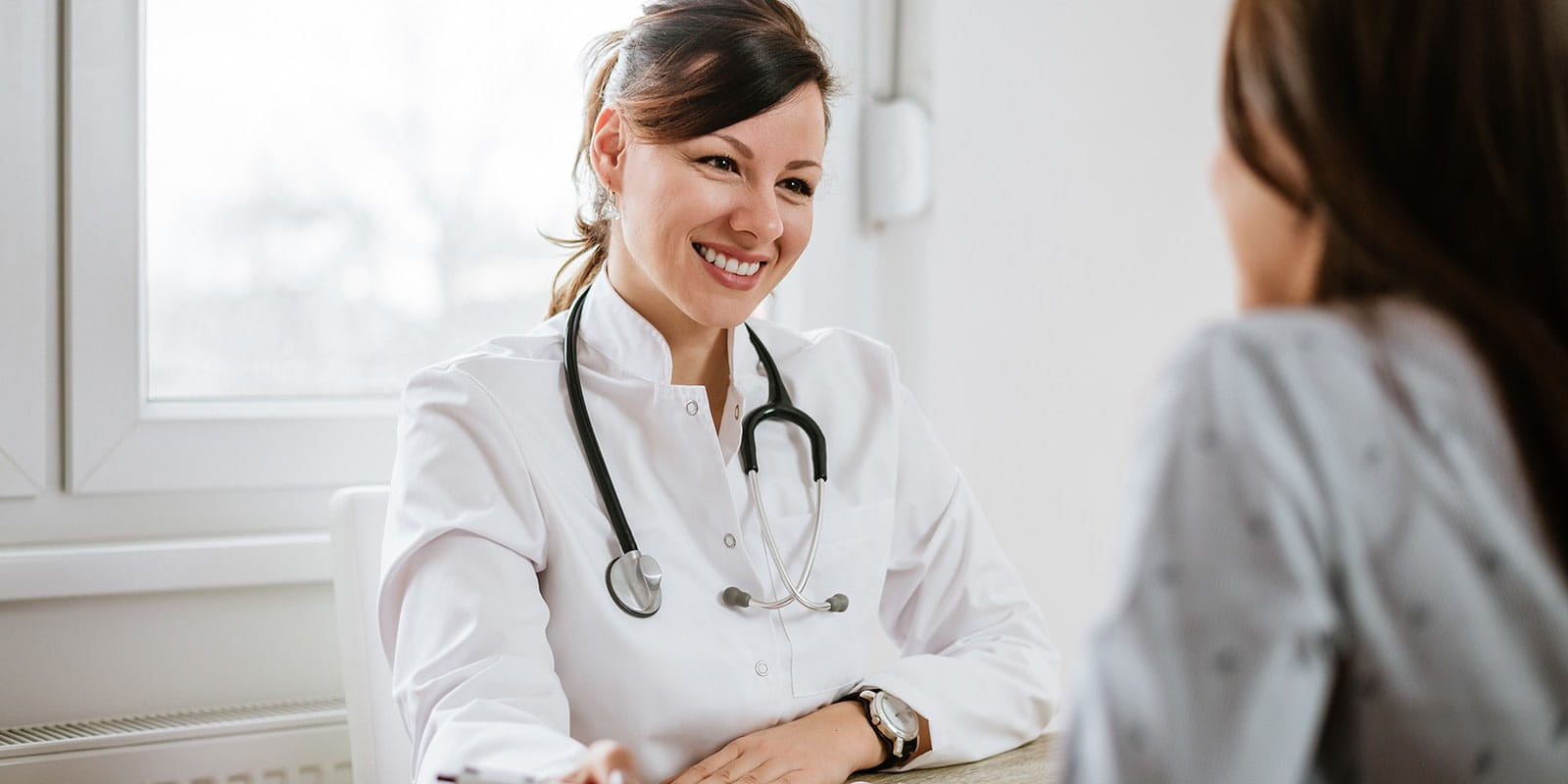 Female doctor talking with patient.