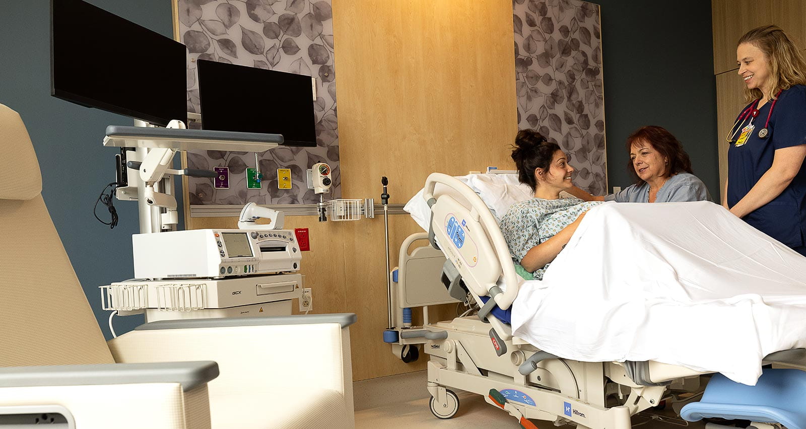 A maternity patient consults with her caregivers