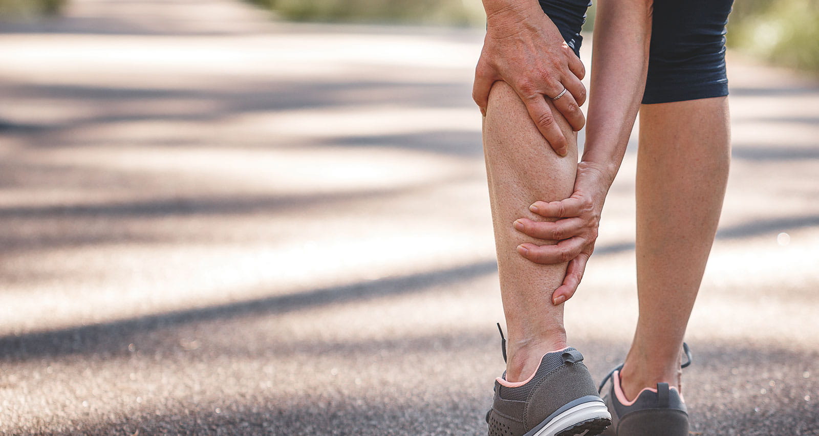 Woman feeling pain of her legs during jogging