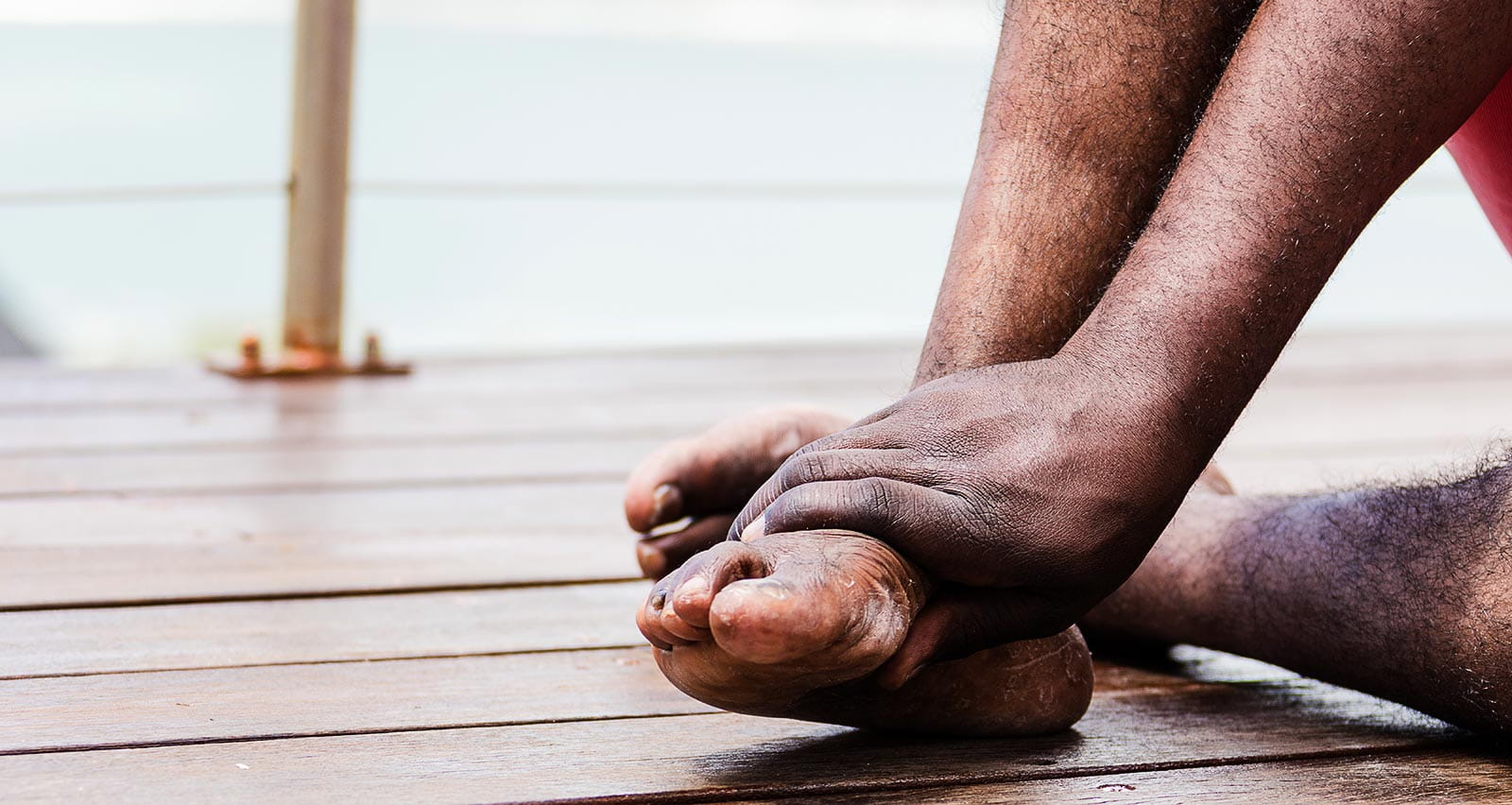 A man holding his painful foot