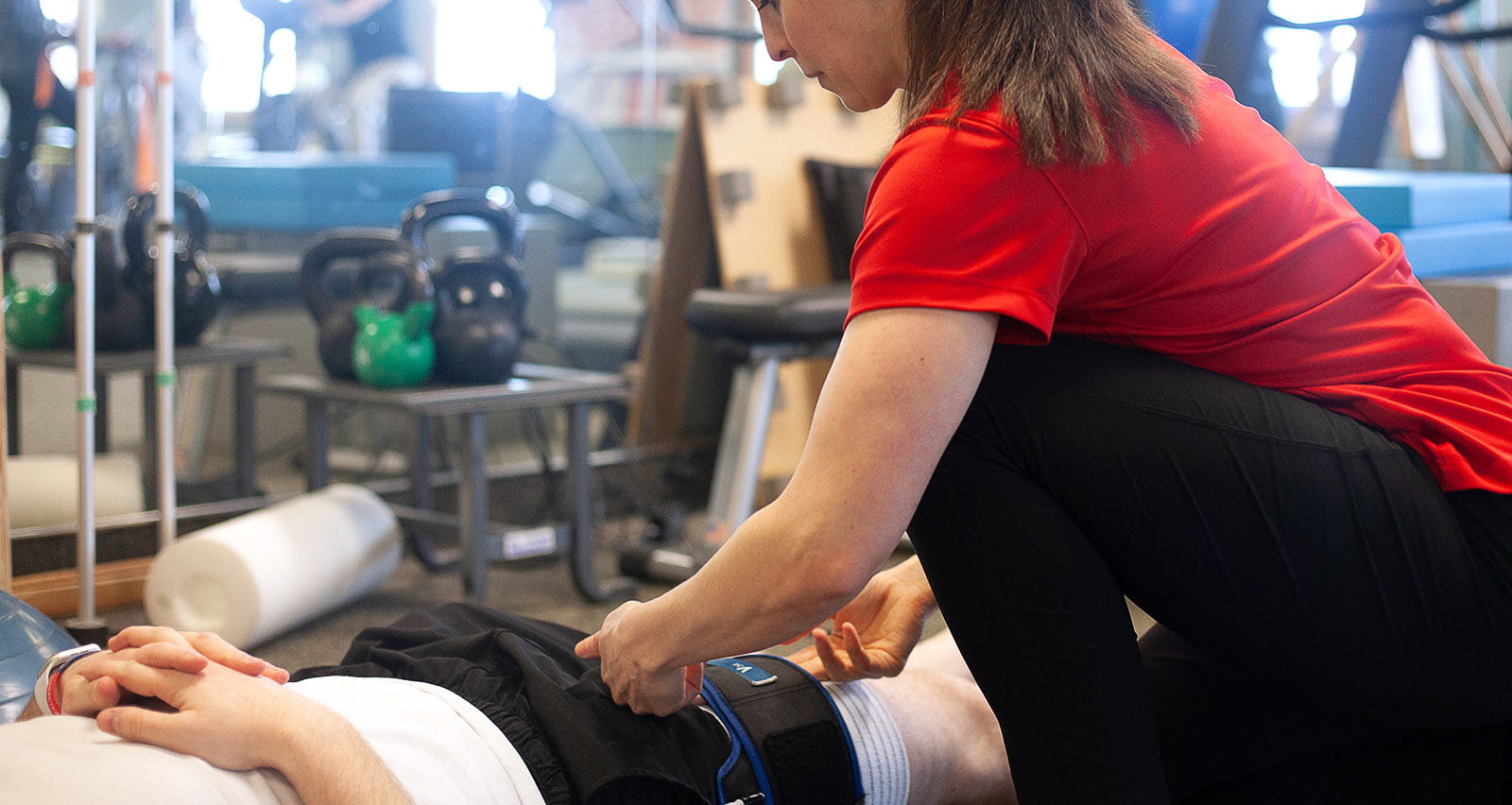 A rehab specialist at UH Mayfield Village Health Center assists a patient
