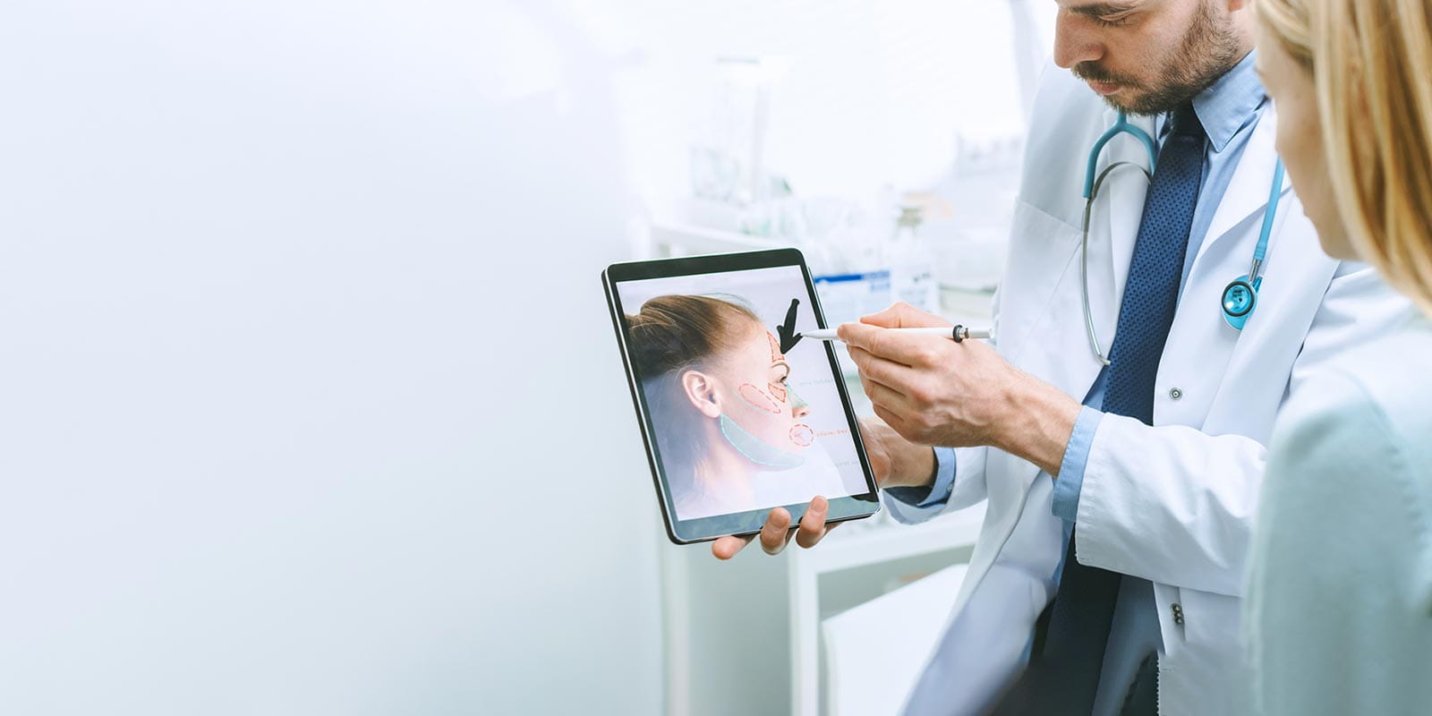 Plastic Surgeon Consults Woman about Facial Lift Surgery