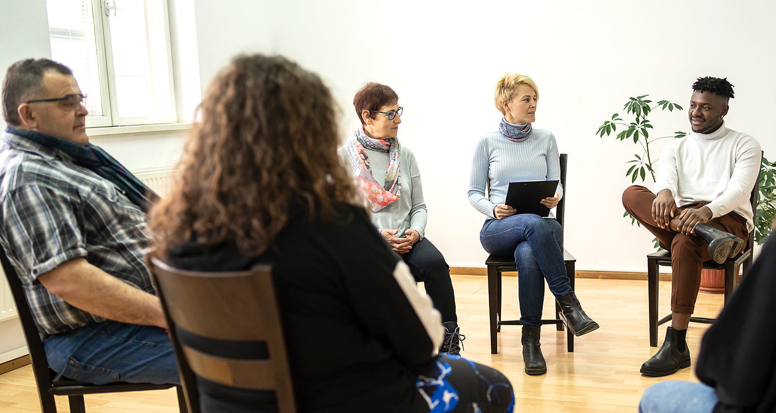 Group therapy support meeting talking about their mental health