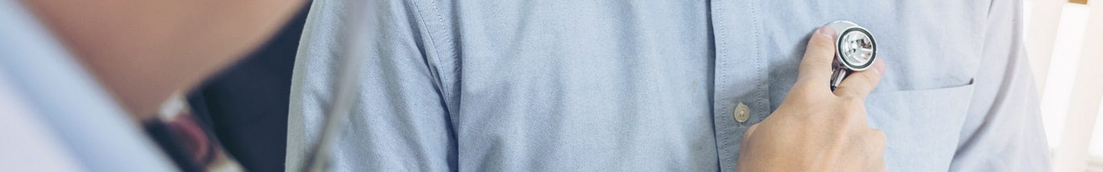 Doctor listening to patient heartbeat with stethoscope