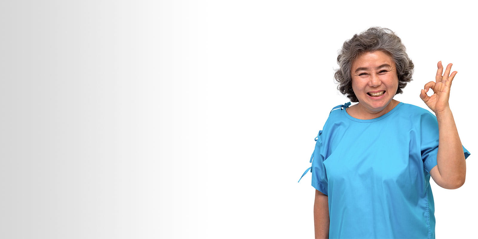 Happy senior female rehab patient showing hand ok