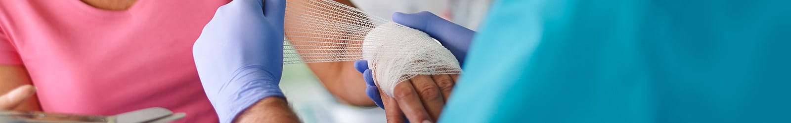 Women receiving medical attention for a hand injury.