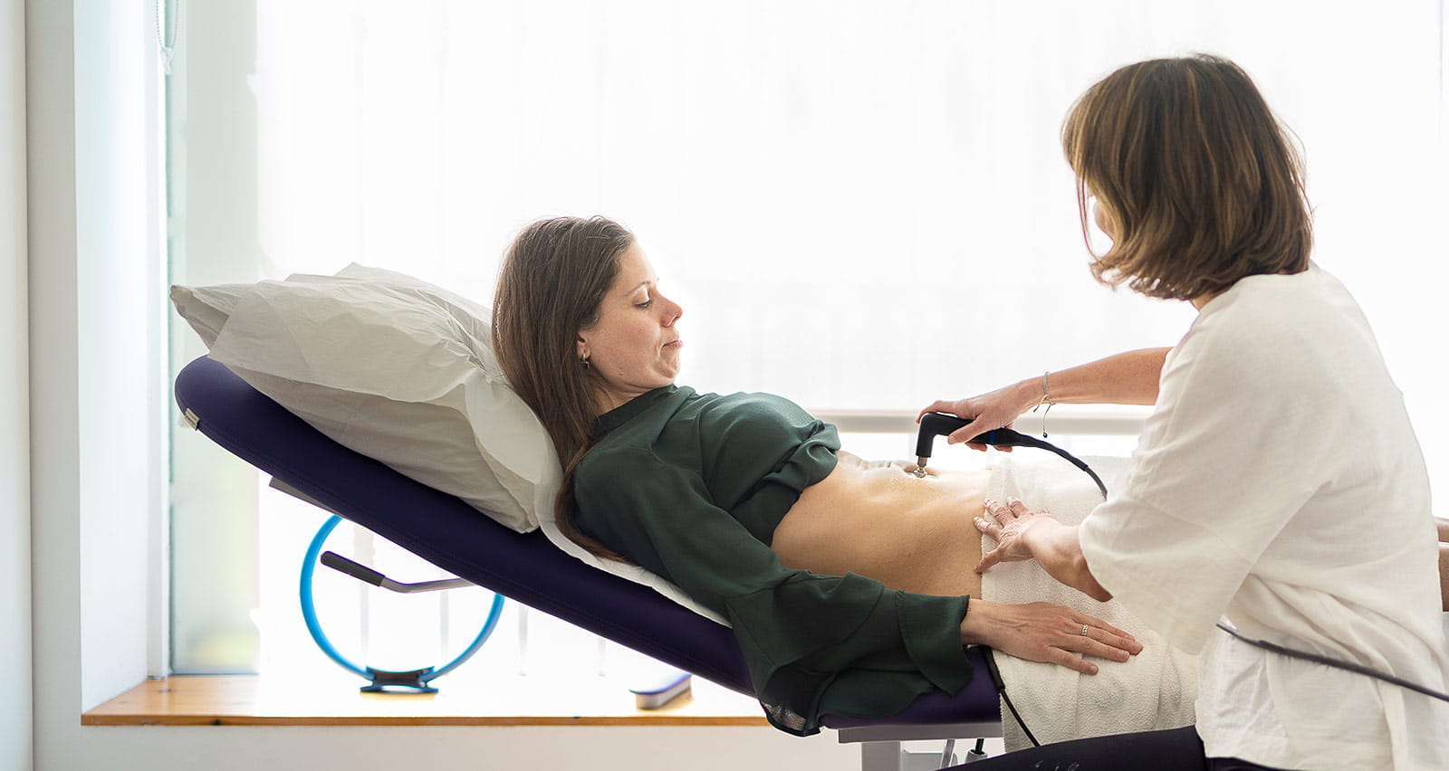 A gynecologist and woman during a pelvic floor recovery treatment with radiofrequency