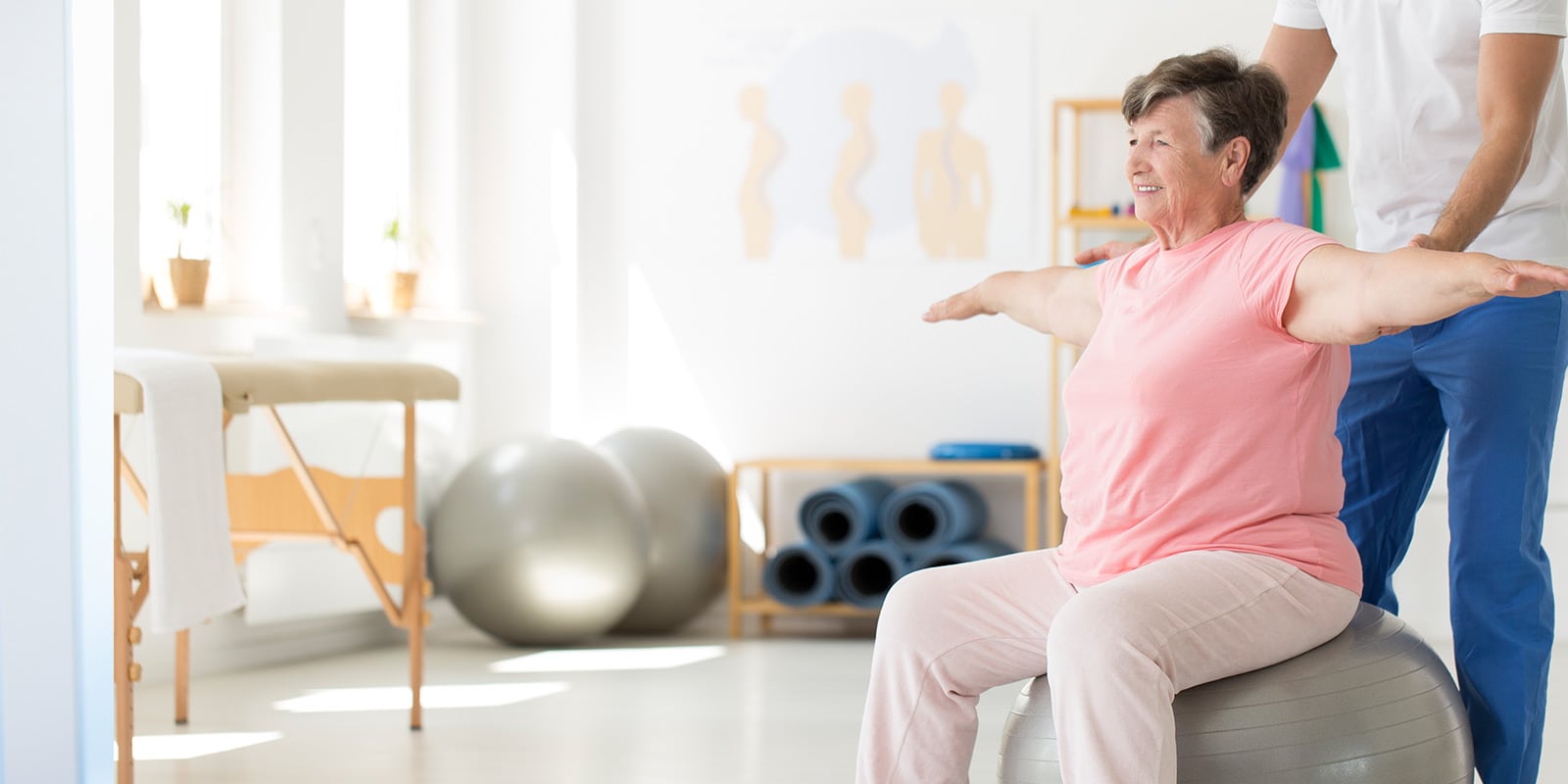 Woman doing rehabilitation exercises with medical professional.