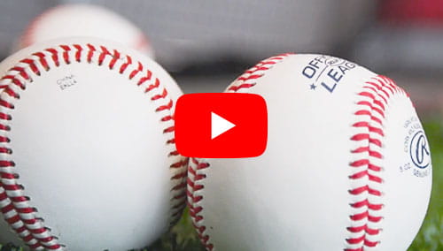 Two baseballs on artificial turf