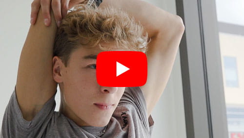 A teenaged male patient at UH Drusinsky Sports Medicine Institute demonstrating a range of motion exercise