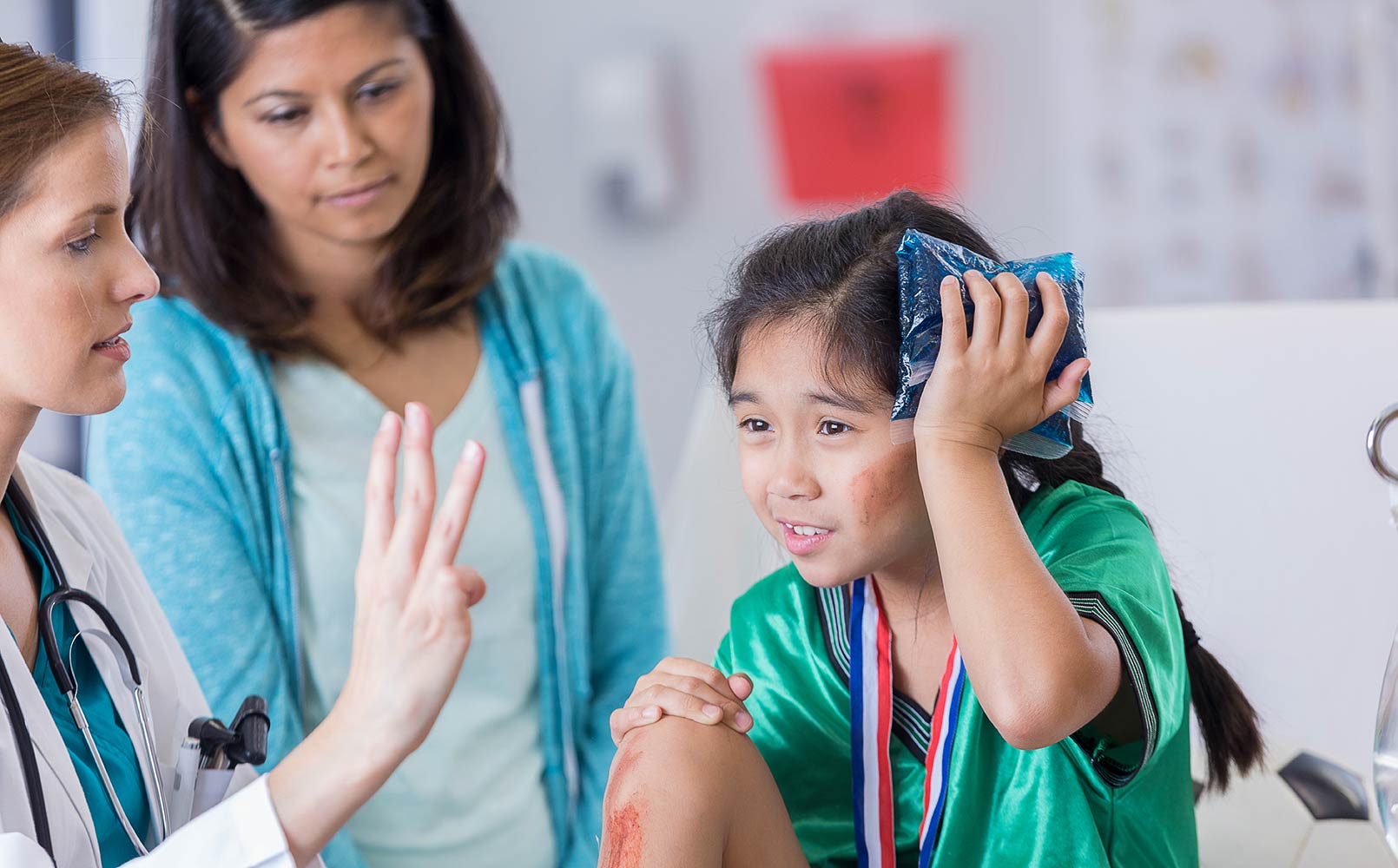 ER doctor examines dazed injured soccer player