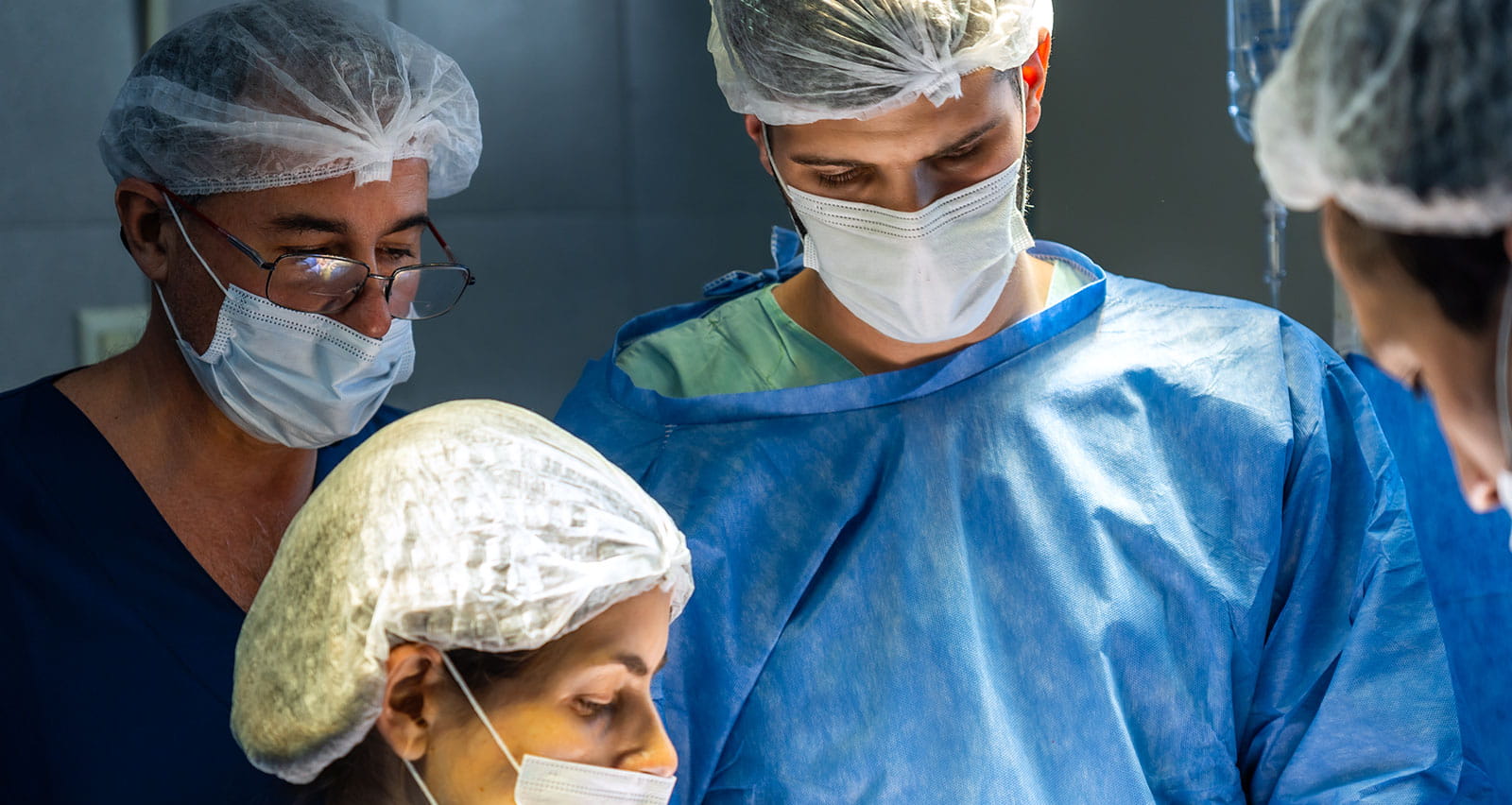 A team of specialists performing abdominal surgery in a hospital operating theater
