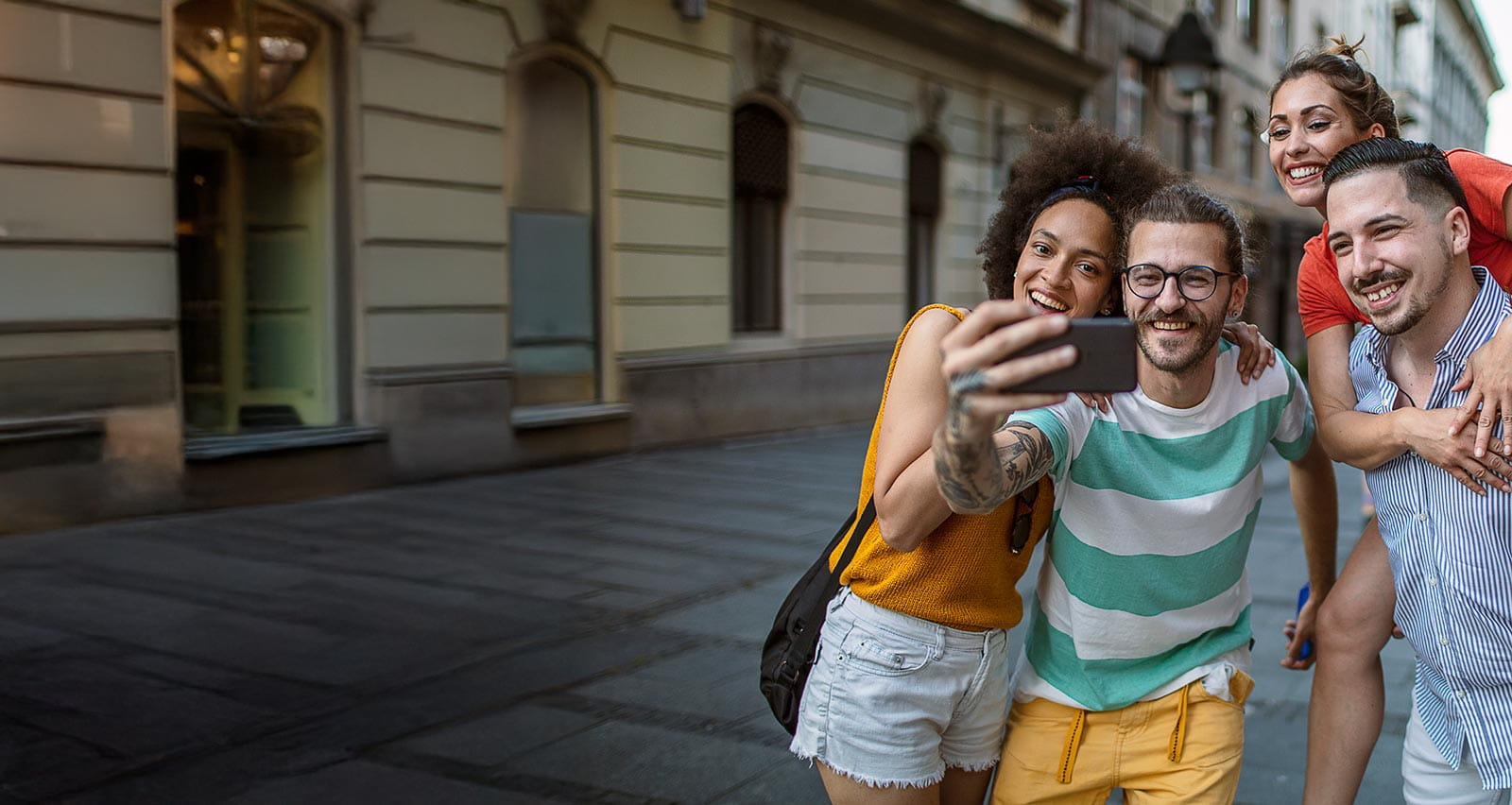 A group of a friends enjoying their holiday and taking selfies with smart phone