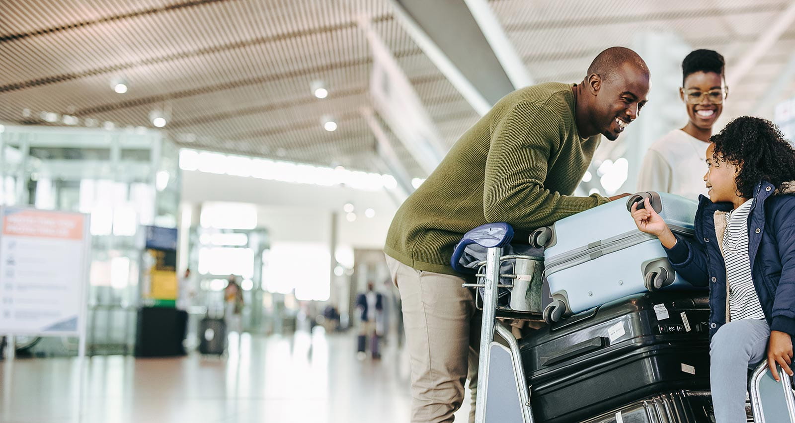 Father and mother waiting with young daughter at airport
