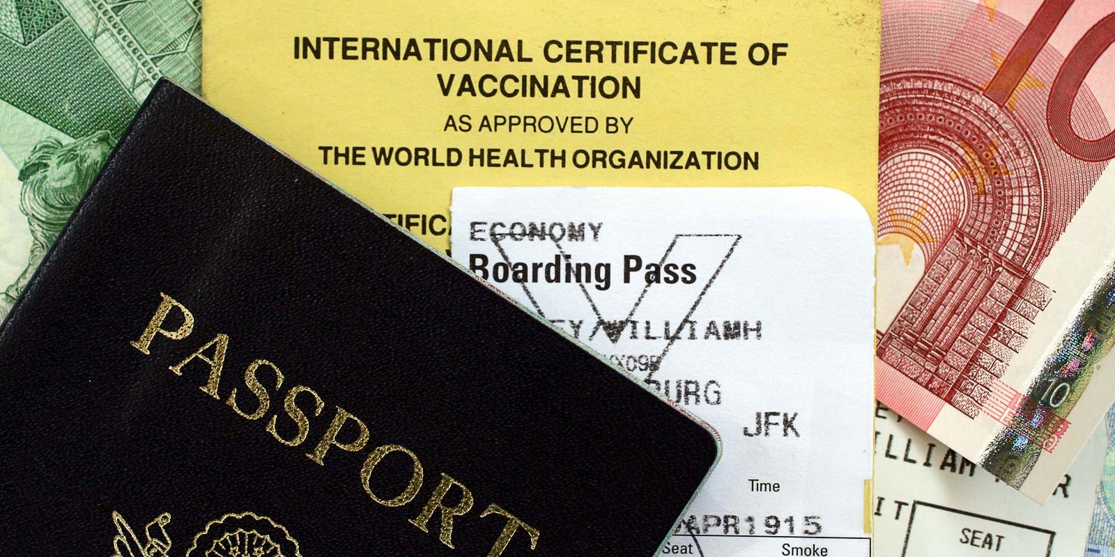 Image of a passport and other travel documents including vaccination certificate