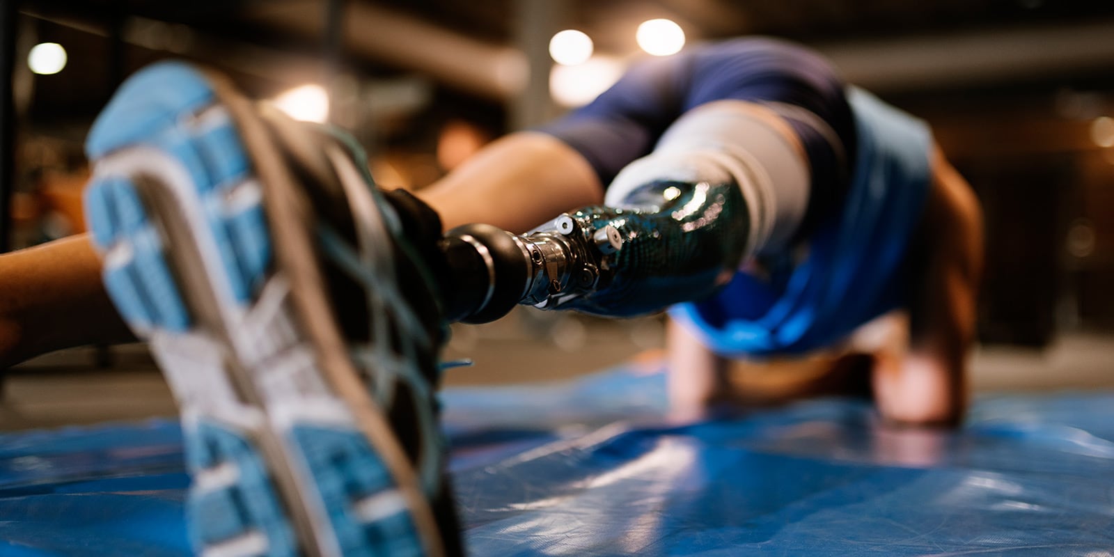 Man with prosthetic limb working out.