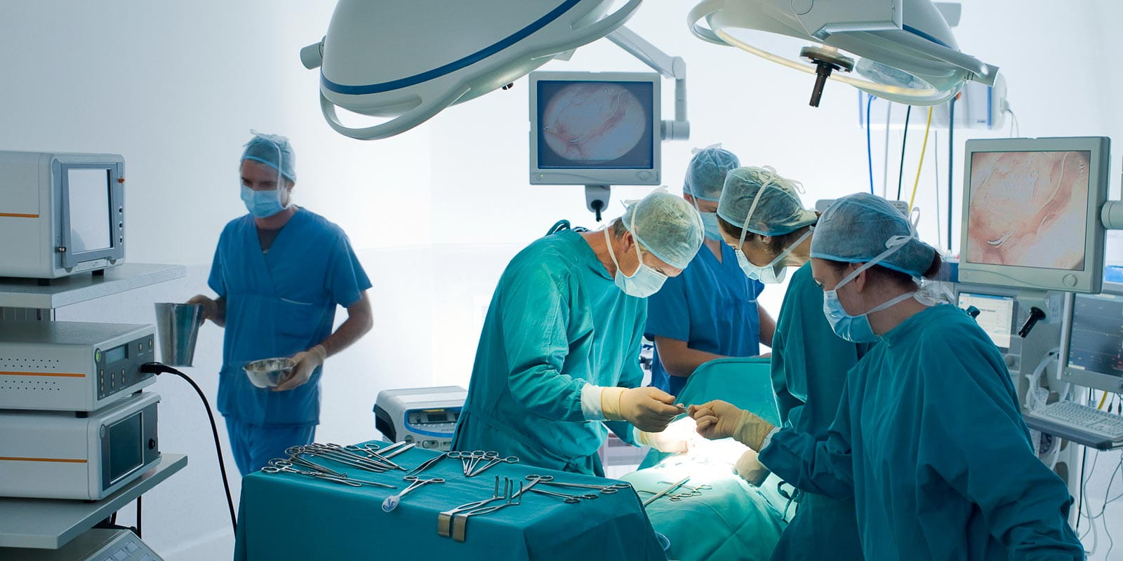 Surgeons performing operation in operating room