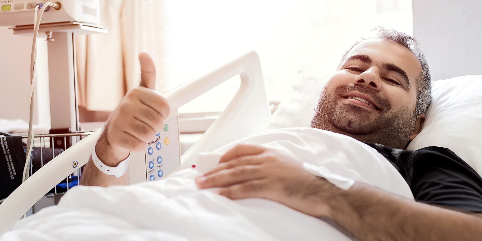 Smiling man in hospital bed