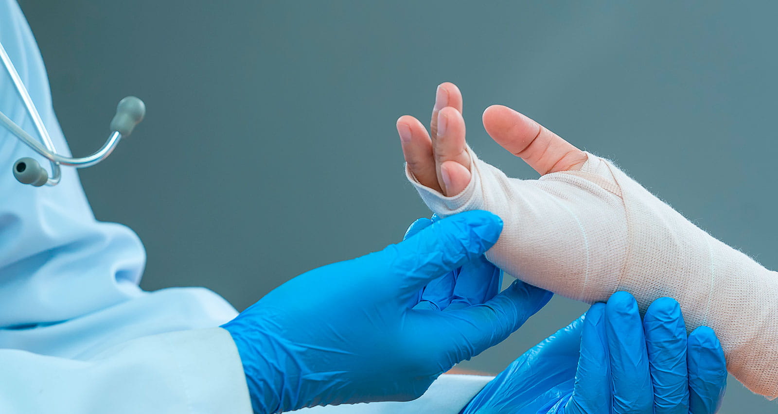A doctor examines a patient's wounded hand