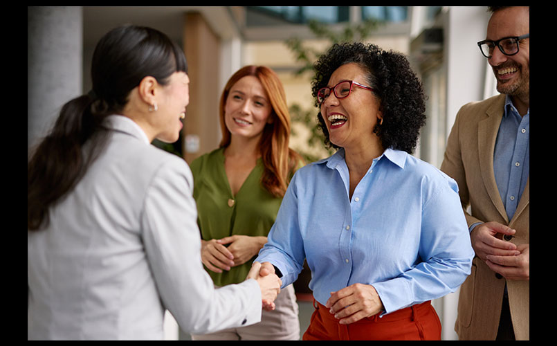 A group of diverse business colleagues engaged in a friendly handshake