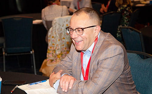 A smiling man in attendance for the Intersection Conference