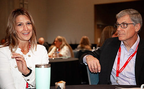 Two attendees having a conversation