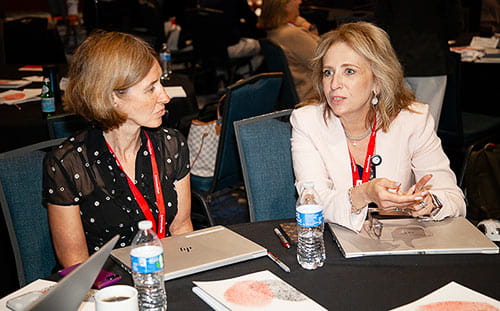 Two women having a discussion at the Intersection Conference