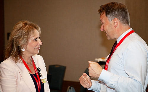 Two attendees discuss the conference’s topics