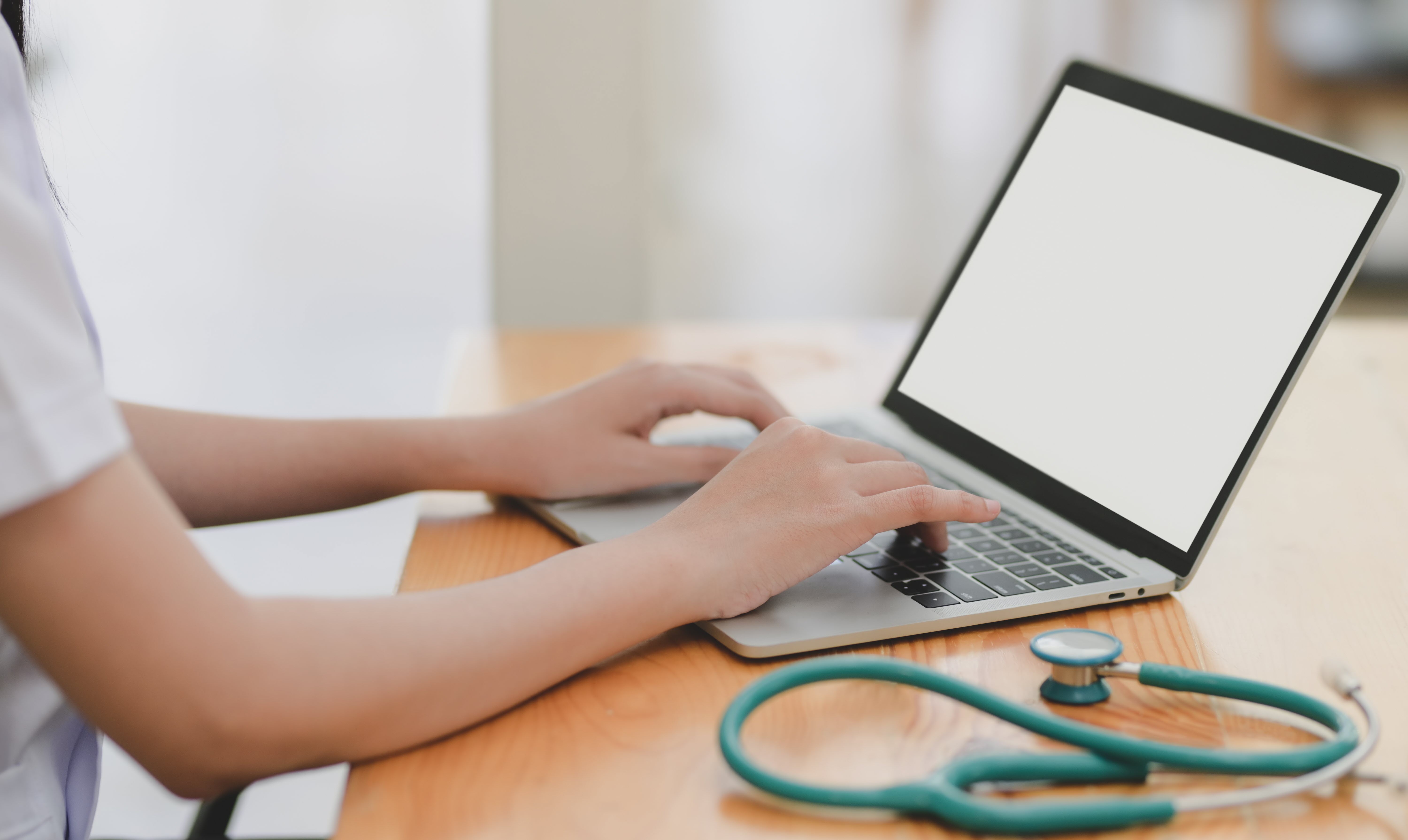 laptop and teal stethescope