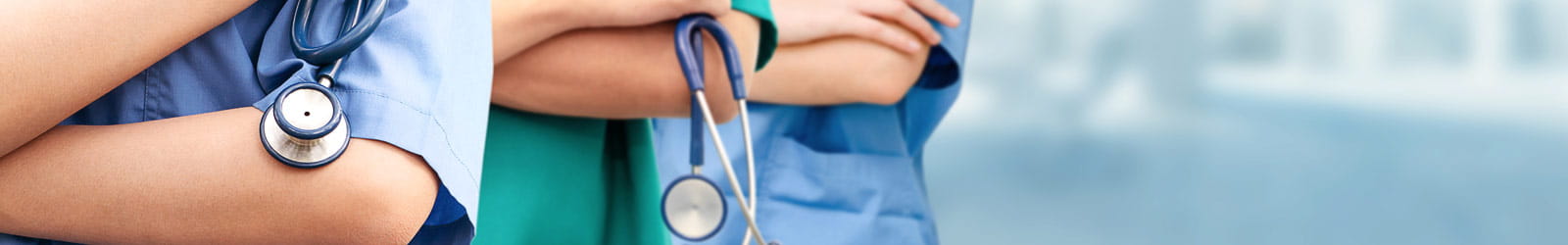 A profile of three nursing professionals standing