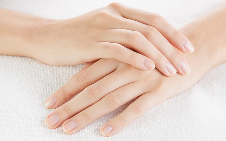 woman's hands resting one atop the other