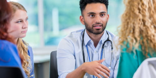 photo of a UH provider talking to a patient and their family