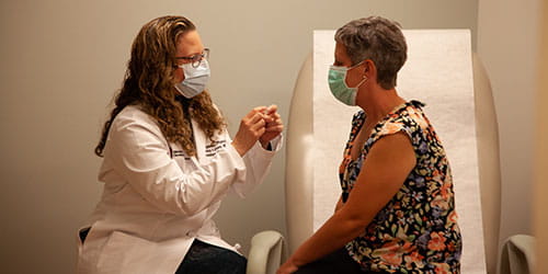 Dr. Lyons with patient for radiation oncology